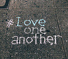 Love one another written in chalk on the driveway