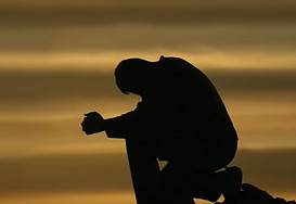 Man kneeling in prayer