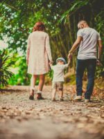 couple walking with their child