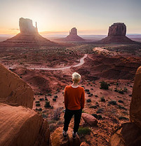 woman peering over a desert view