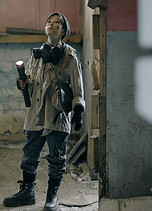 woman shining flashlight in abandoned building